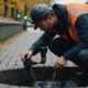 Technician examining drain pipe for lining services