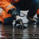 Technician using equipment to clean a storm drain