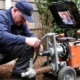 Plumber relining a pipe with advanced tools